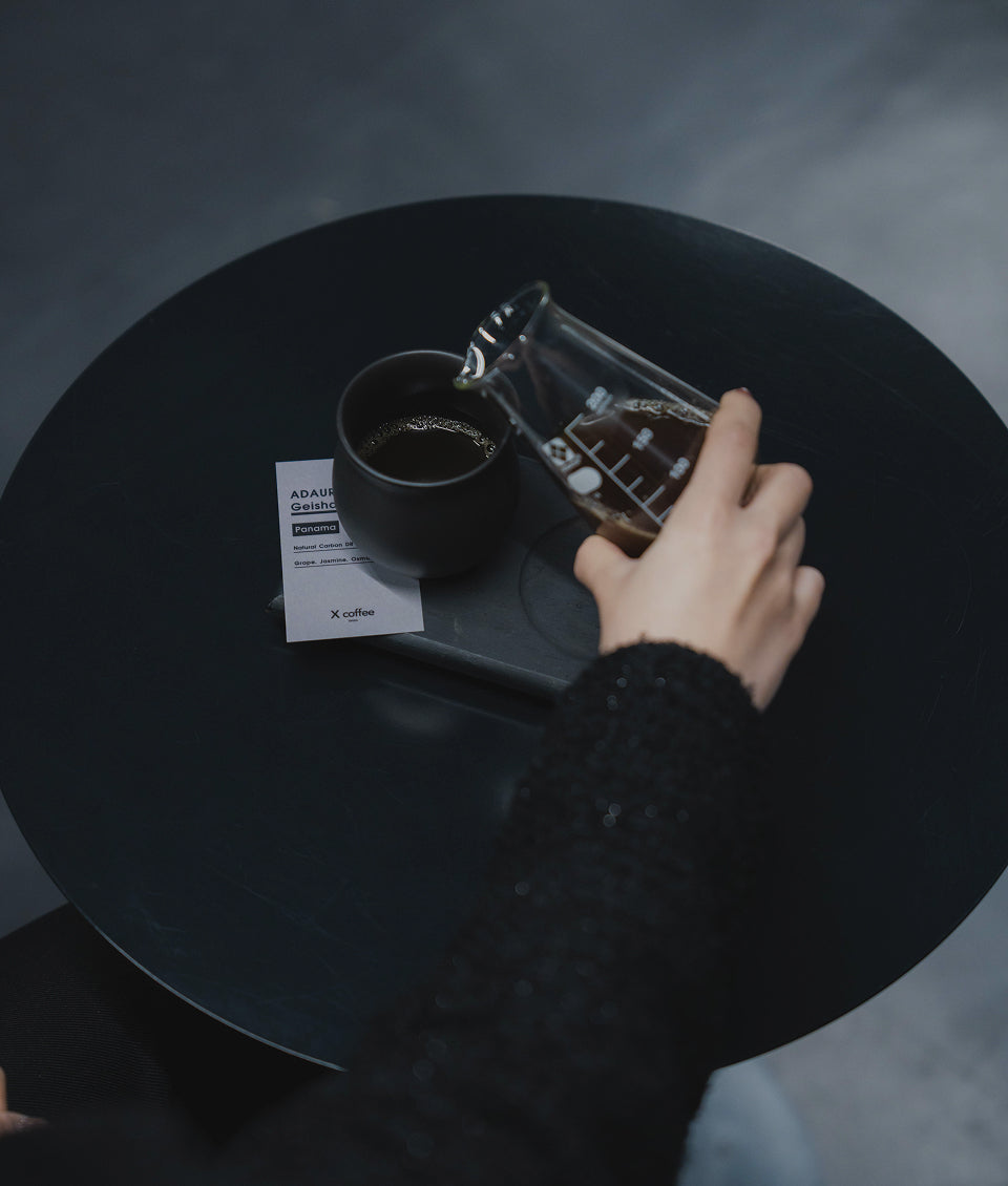 X coffeeのカウンターでコーヒーを抽出するスタッフ